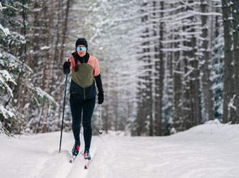 Cross-country skier on a trail in the forest at Domaine Saint-Bernard
