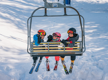 Three kids in a ski lift at Mont Blanc