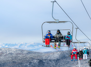 Skiers in the chairlift at Mont Grand-Fonds