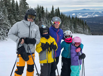 A family skiing at Mont Grand-Fonds