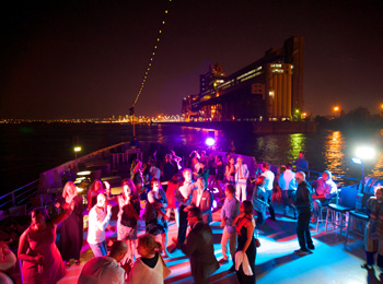 People dancing on a night cruise.