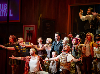 The cast of the Pub Royal musical on the stage during the show.