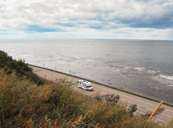 RV on a seaside road