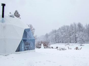 Snow-covered dome and surrounding forest landscape