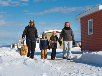A family ice fishing at Glaces du Fjord