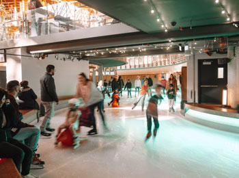 Families skating on the indoor rink at Mega Parc